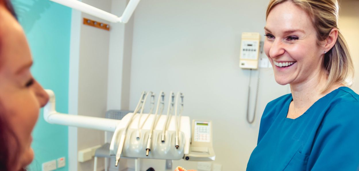 Dentist chatting with a patient during a first visit consultation at Glendair Dental