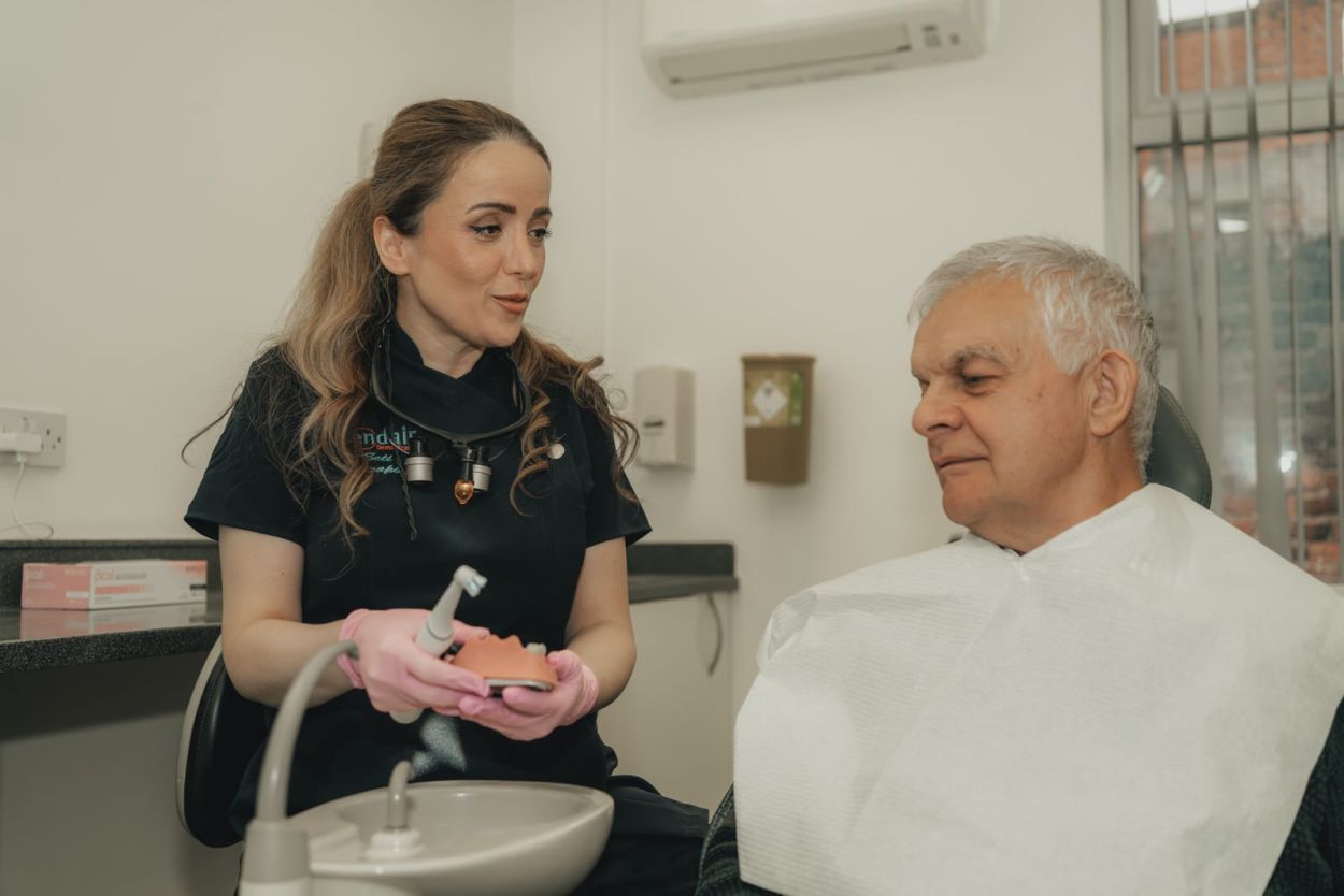 Dentist discussing dental bridge treatment with a patient at Glendair Dental