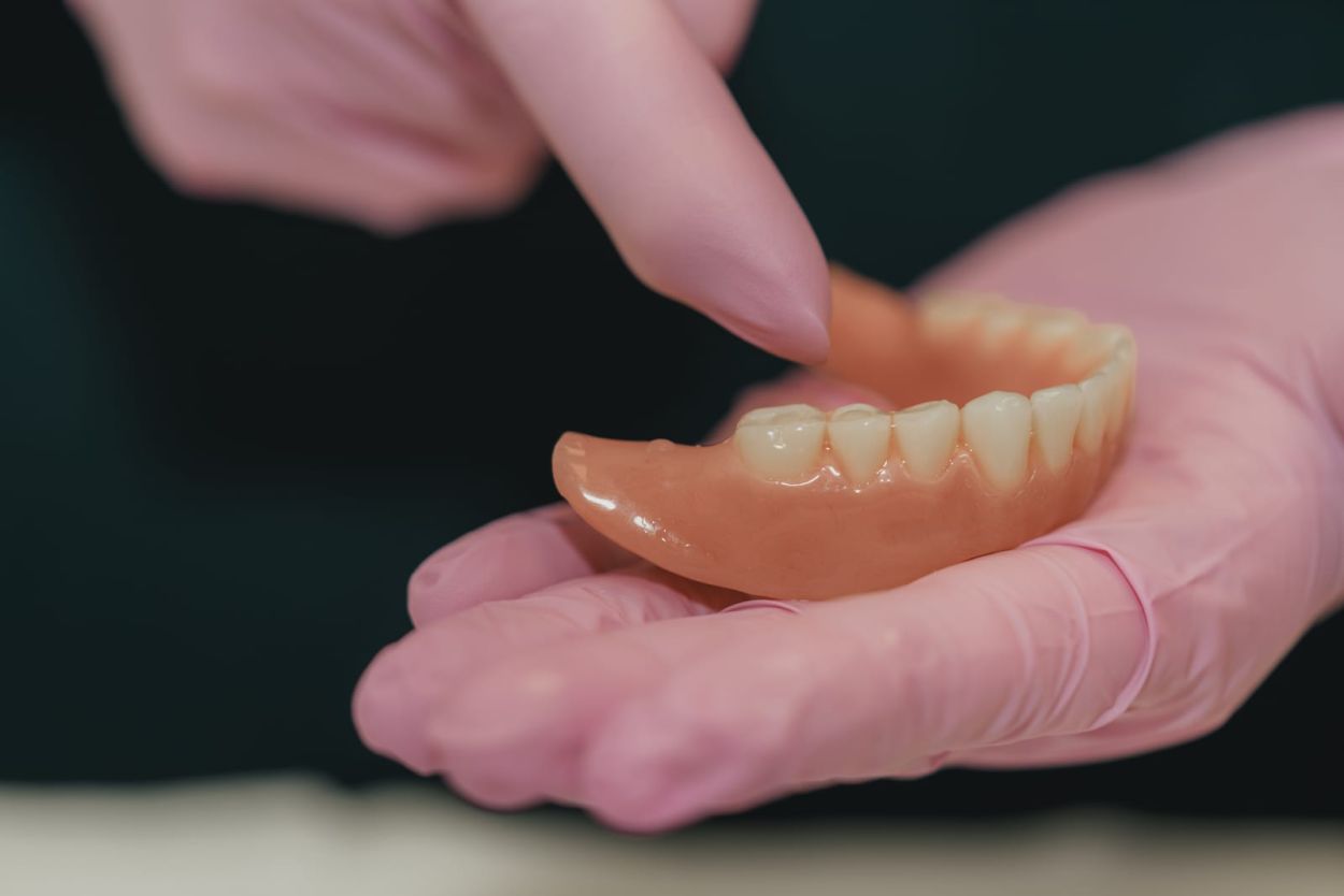 Dentist discussing denture options with a smiling patient at Glendair Dental