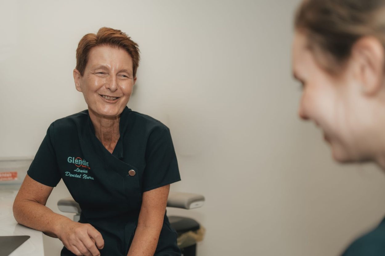Dentist talking with a patient during a first visit at Glendair Dental