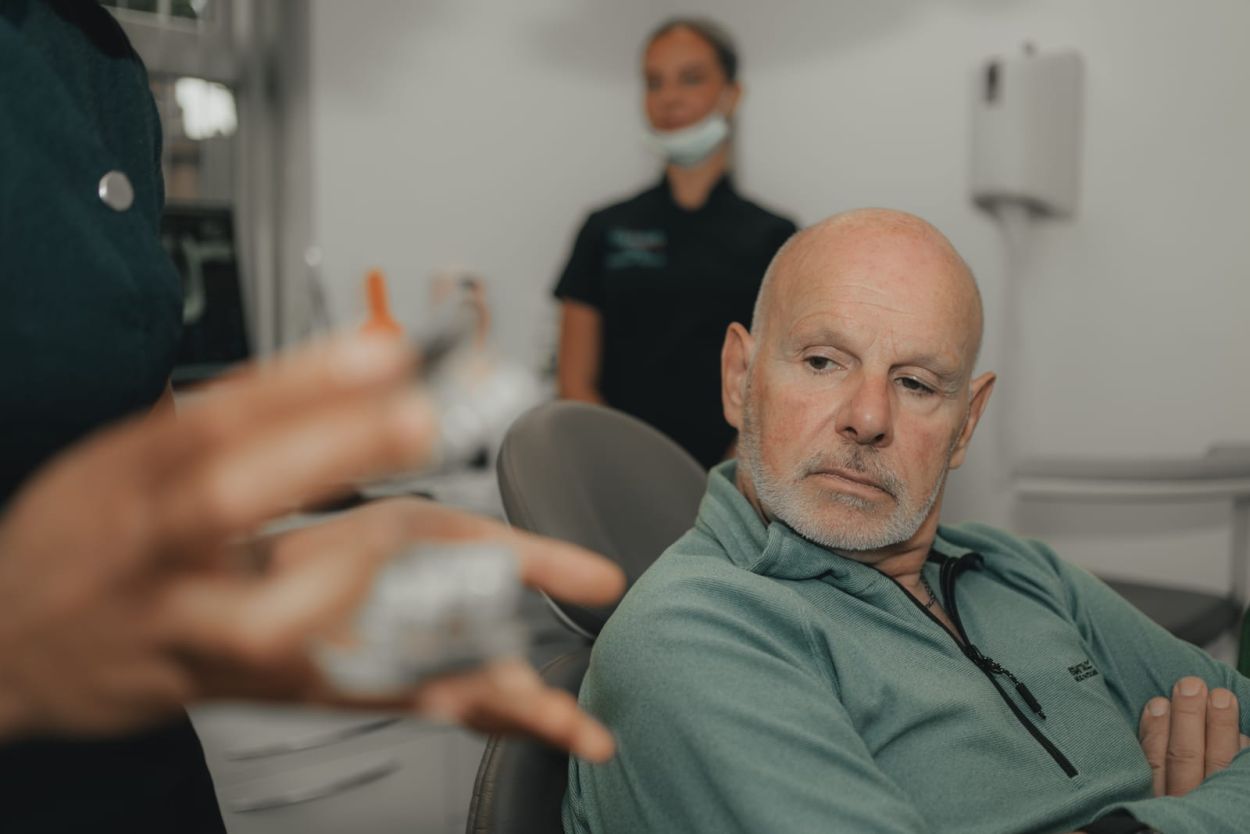 Dentist discussing composite bonding treatment with a patient at Glendair Dental